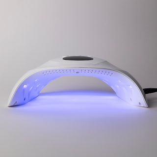 De LAKKIE lamp. Een UV/LED lamp die je gellak snel laat drogen. Met 58 watt is dit een krachtige lamp. Op de bovenkant van de lamp zit de timer knop voor 30, 60 of 99 seconden droogtijd. In het lcd scherm kun je de droog tijd zien, die aftelt. 